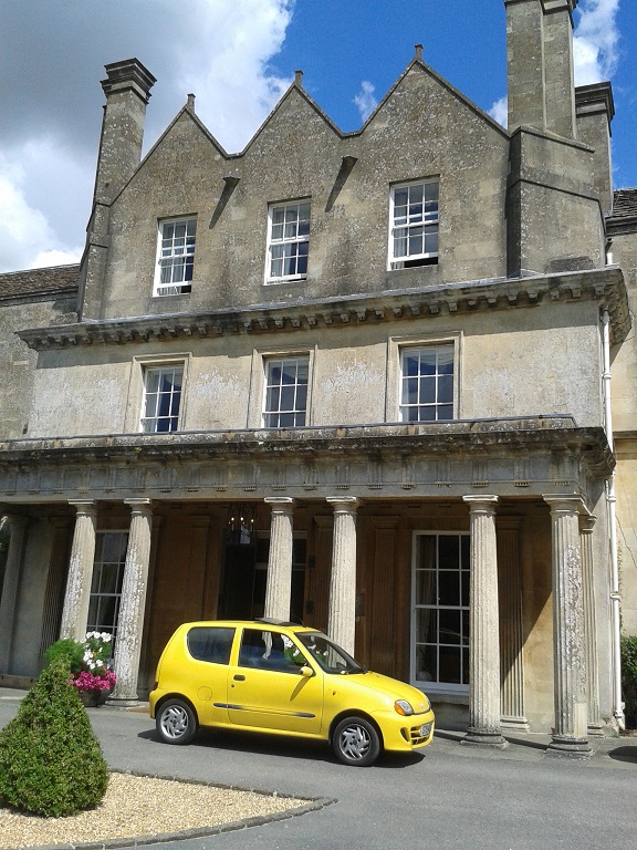 lucknam park entrance with yellow car