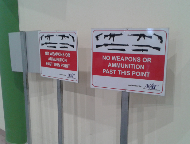 holiday papua new guinea no weapons sign at Port Moresby airport