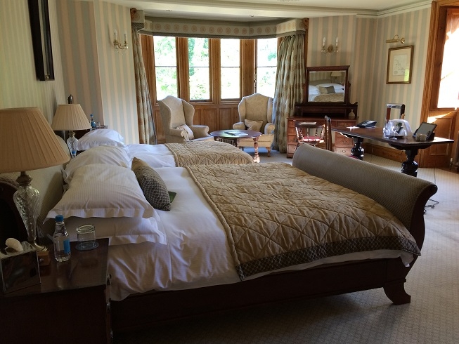 bedroom with sleigh bed at the manor house castle combe