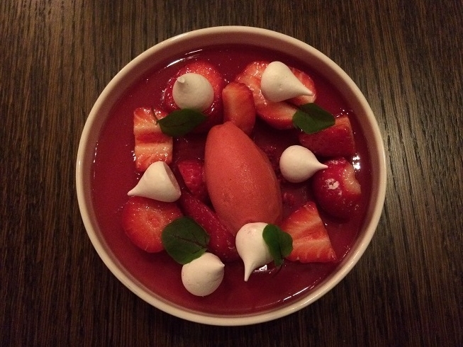 Buttermilk panna cotta topped with a salad of wild strawberries