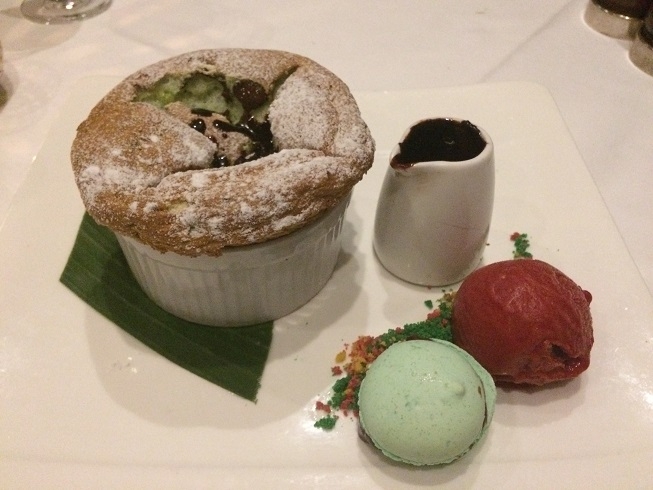 Pistachio souffle with chocolate sauce and raspberry sorbet