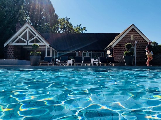 The outdoor swimming pool and pool house at Maison Talbooth hotel in Essex 