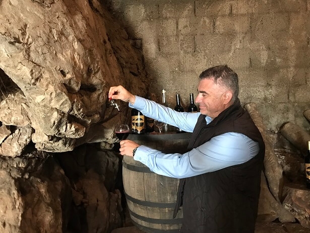 Pouring red wine straight from the rock in Montenegro