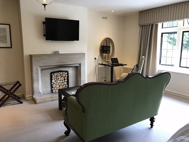 The sofa and log fire feature in our large bedroom at the hare and hounds hotel near Tetbury