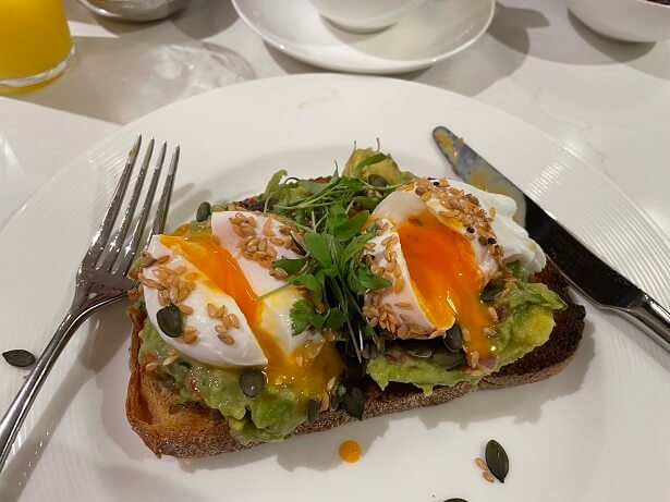 poached eggs and smashed avocado on toasted sourdough for breakfast at The Mayfair Townhouse