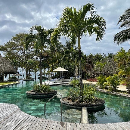 Le Lux Morne Mauritius swimming pool with palm trees
