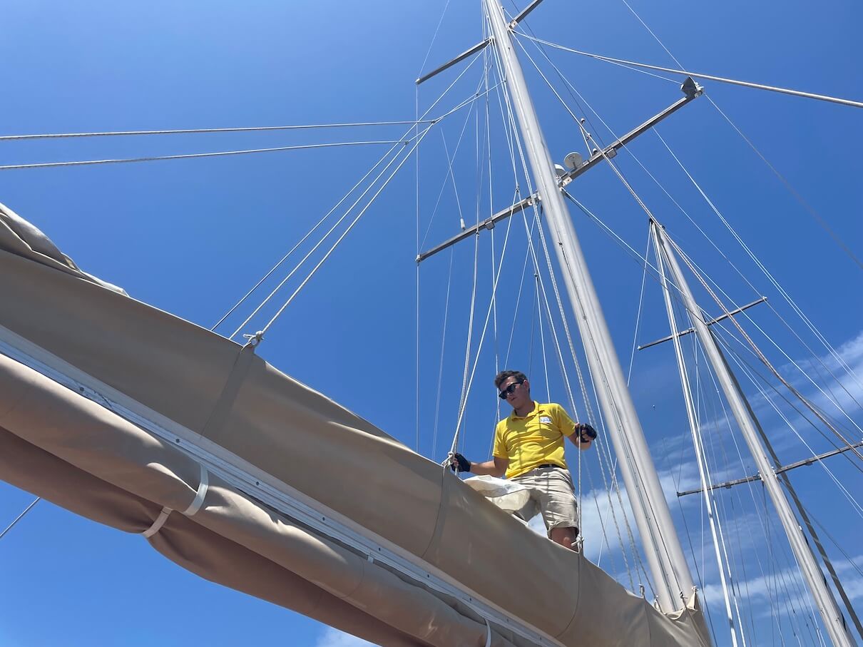 crew putting up the sails on a traditional sailing ship in Turkey
