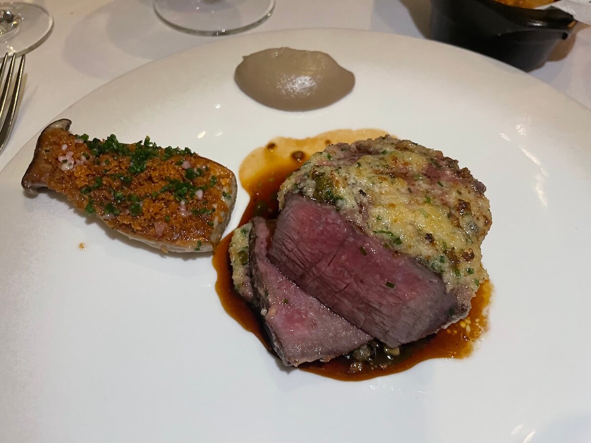 Our main course of salt-aged beef fillet with crushed marrowbone, mushroom bourguignon and triple-cooked chips at Northcote hotel