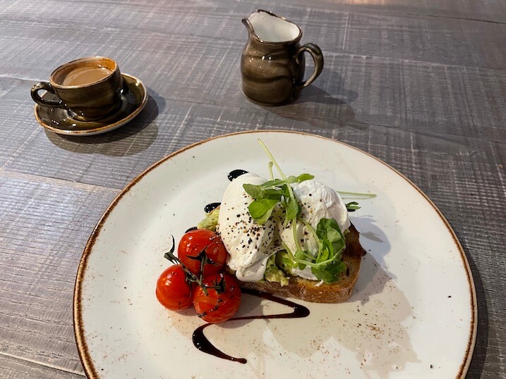 Breakfast of avocado, poached eggs and sourdough toast at Henry's restaurant Breakfast of avocado, poached eggs and sourdough toast at Henry's restaurant