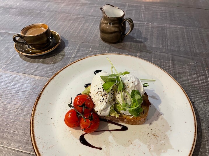 Breakfast of avocado, poached eggs and sourdough toast at Henry's restaurant