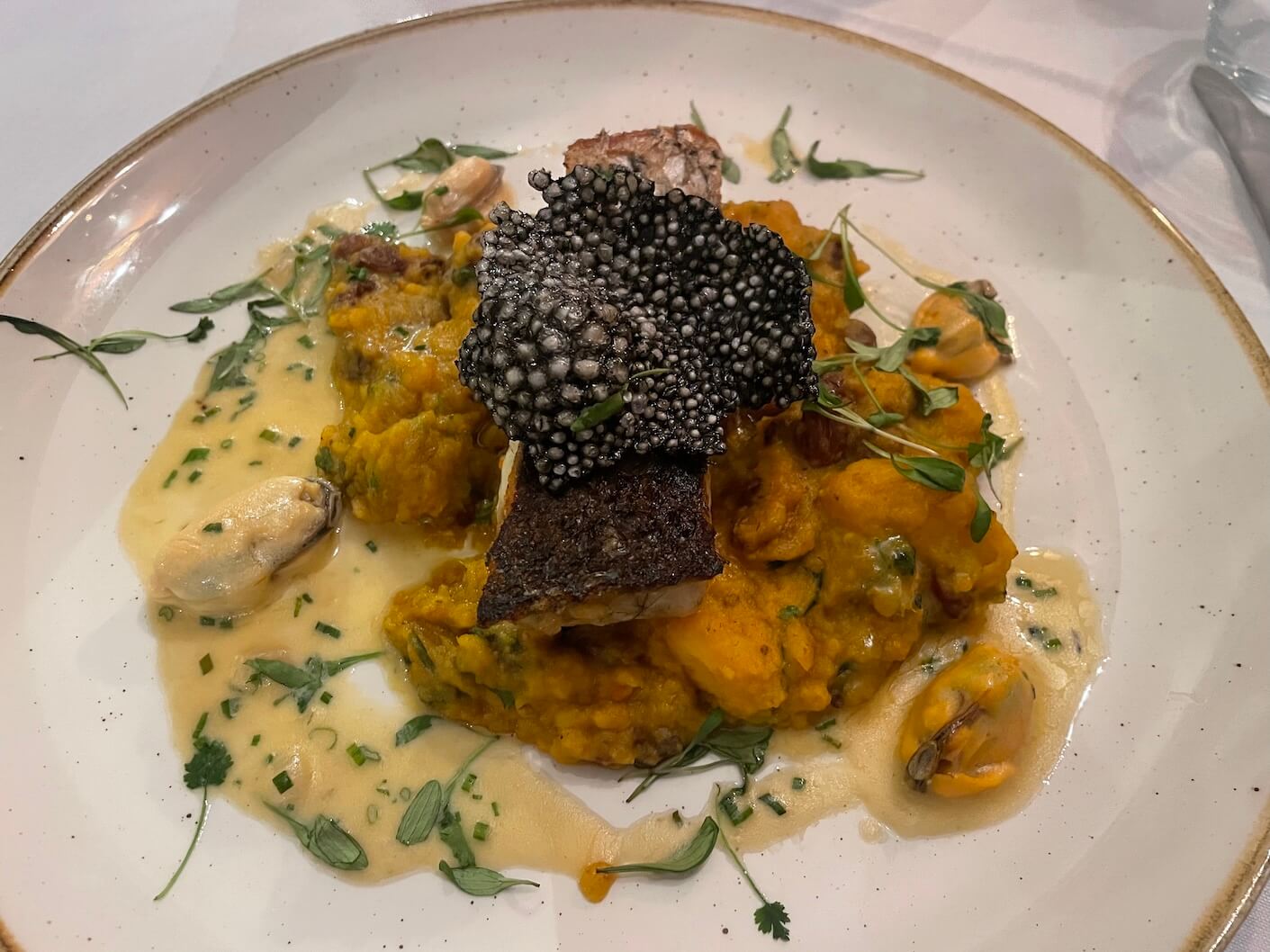 Stone Bass fillet with red lentil and squash dhal