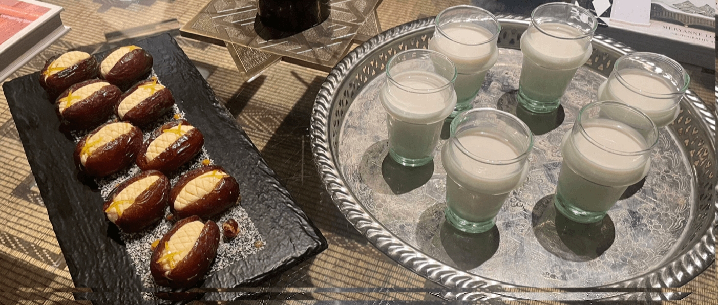 glass of orange blossom milk and dates stuffed with almonds
